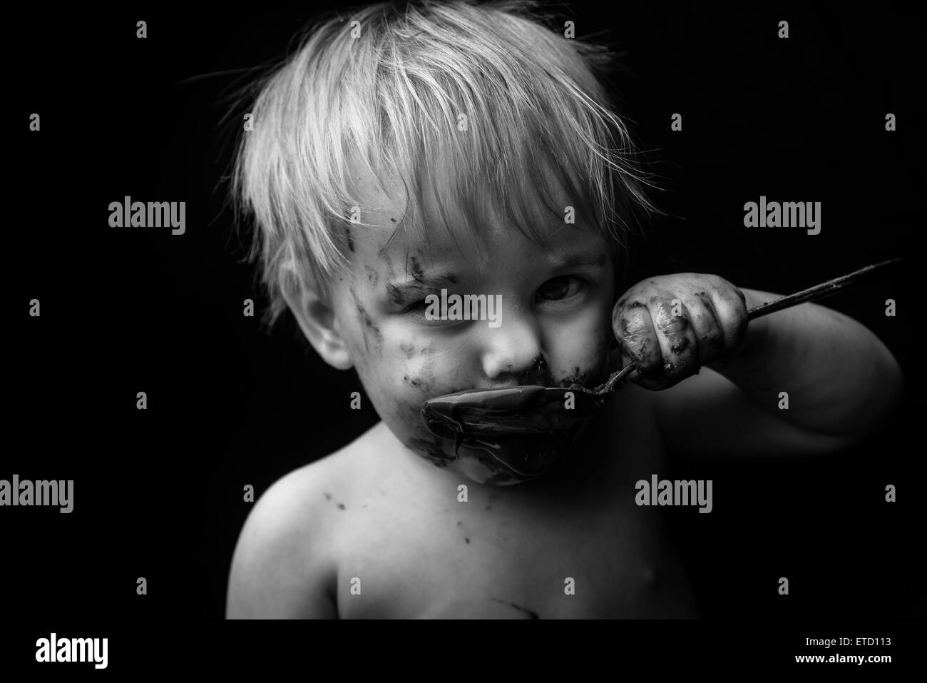 A young boy with chocolate on his face. Stock Photo