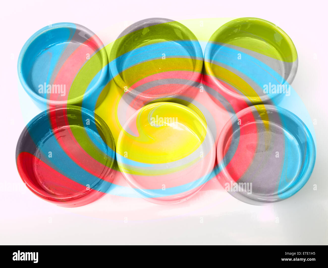 Light blue, green, yellow and pink twirling strips abstract background Stock Photo