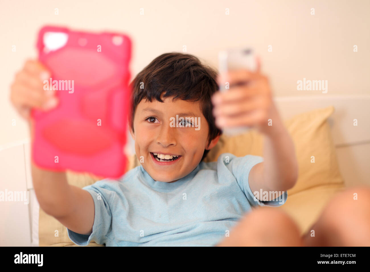 Young boy making selfie pictures with tablet computer - with shallow depth of field Stock Photo