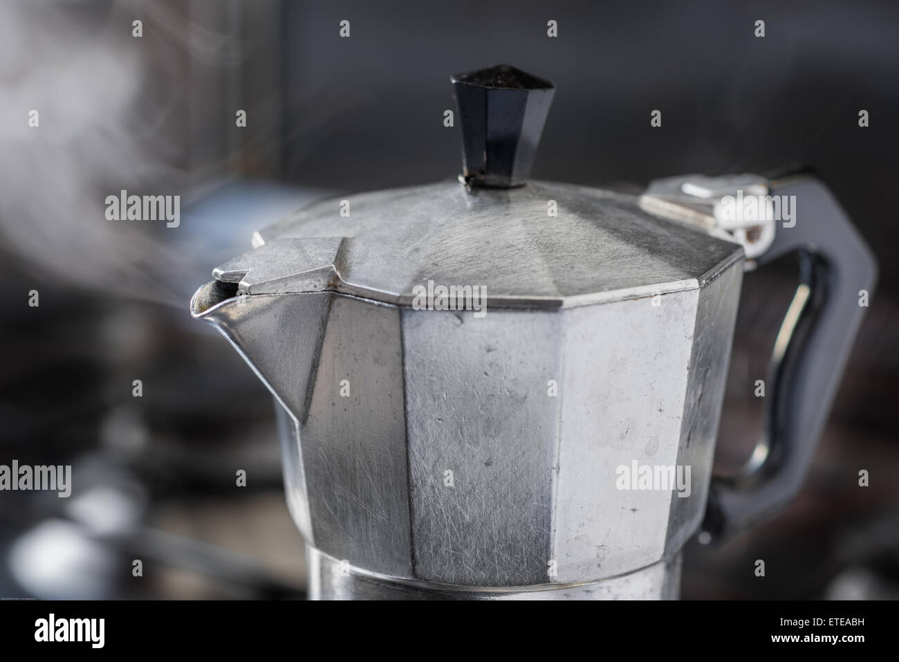 https://c8.alamy.com/comp/ETEABH/italian-traditional-coffeemaker-with-steam-blowing-out-from-the-spout-ETEABH.jpg