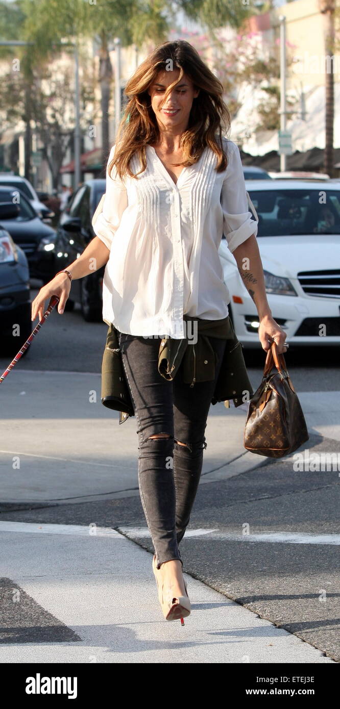 Elisabetta Canalis walking her pet dog in high heels after having lunch