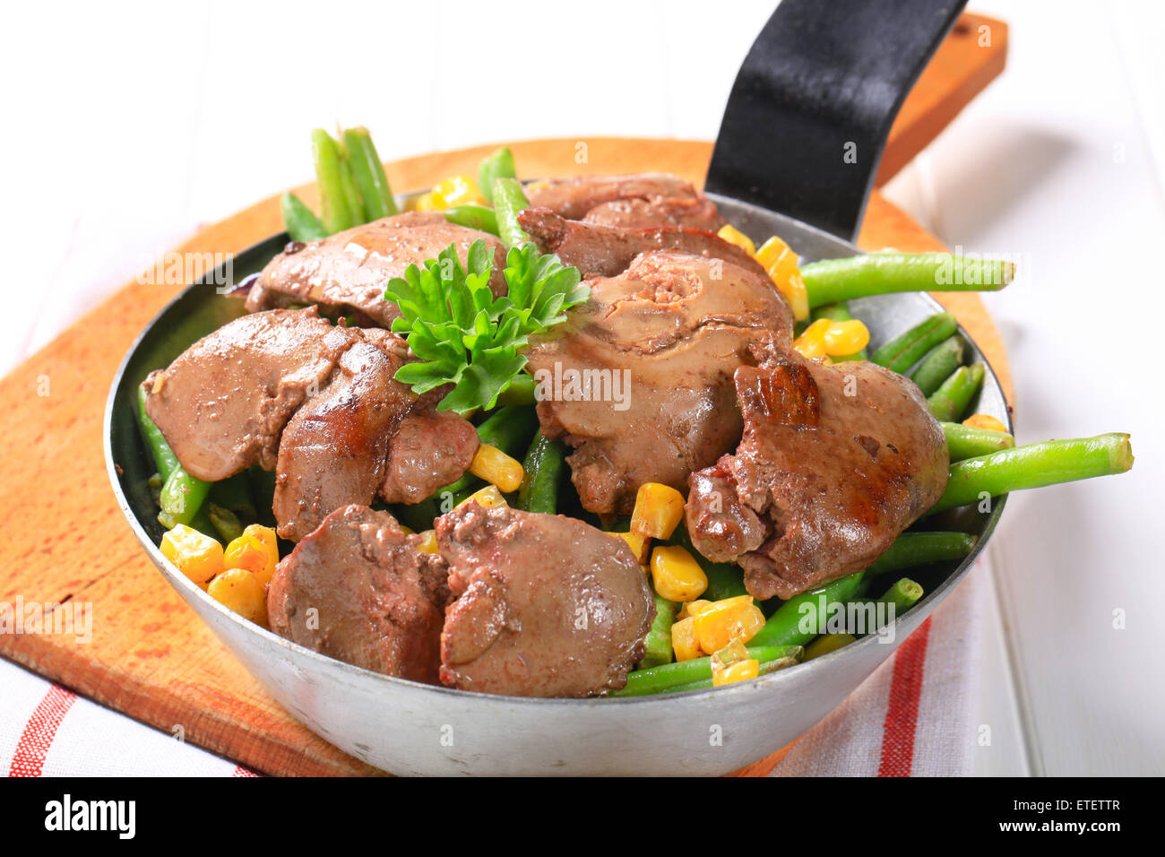 Panfried chicken livers with green beans and sweetcorn Stock Photo Alamy