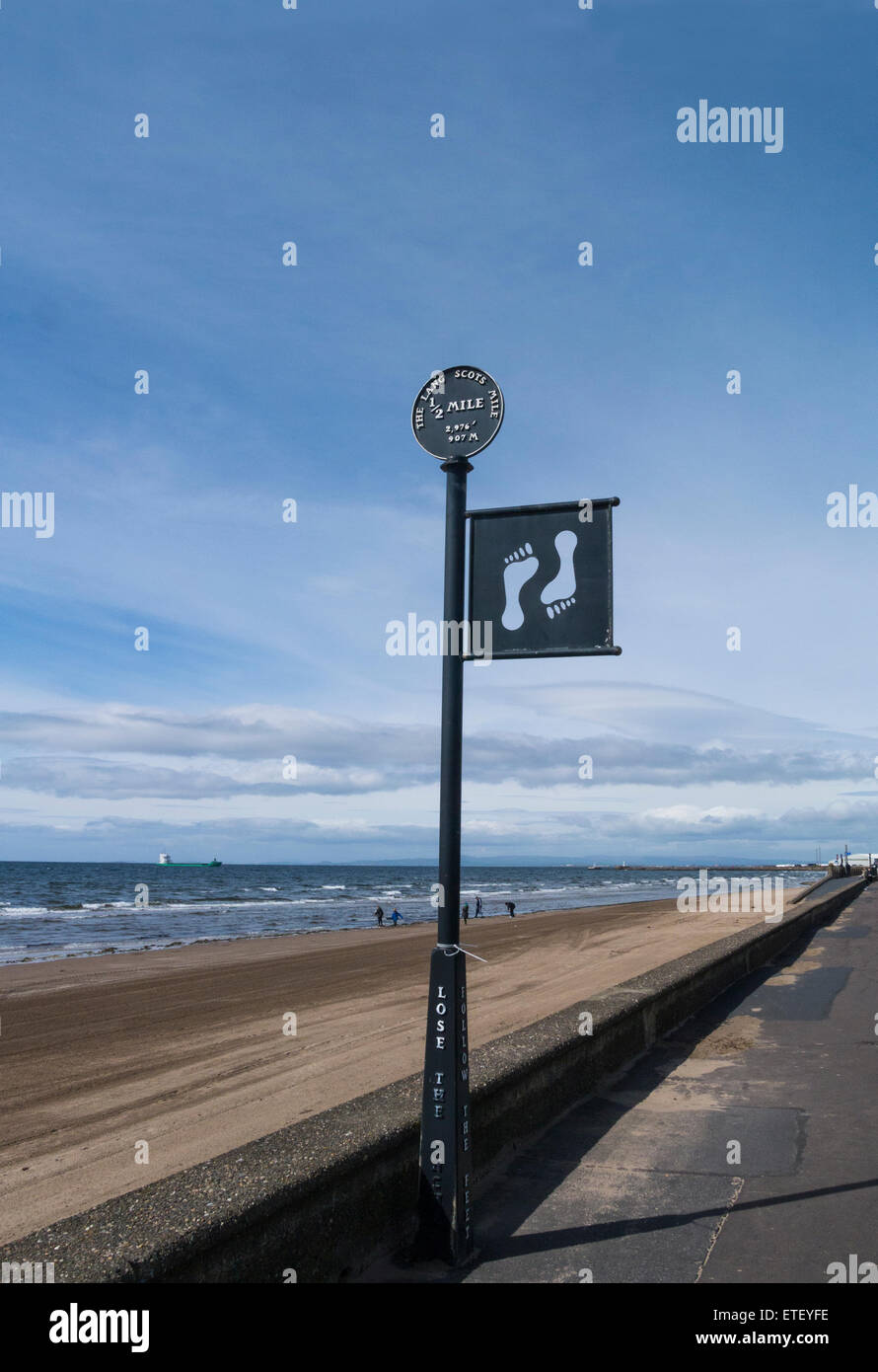 Way marker half way along the Lang Scots Mile Ayr Scotland sea front walk Firth of Clyde on lovely May day weather blue sky Stock Photo
