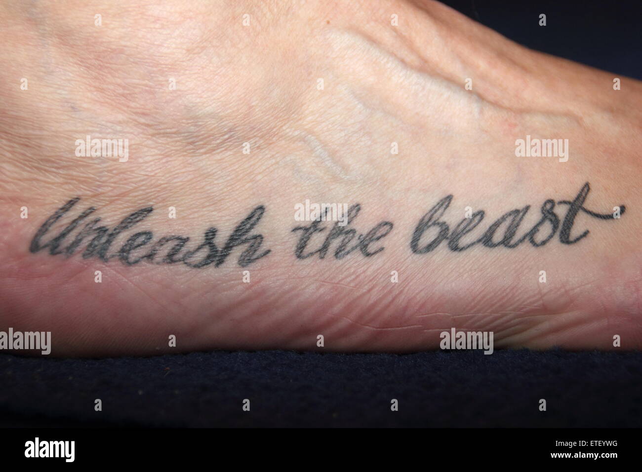 Veteran toe wrestling champion, Alan 'Nasty' Nash unveils a tattoo at the World Toe Wrestling Campionships, Derbyshire 2015 Stock Photo