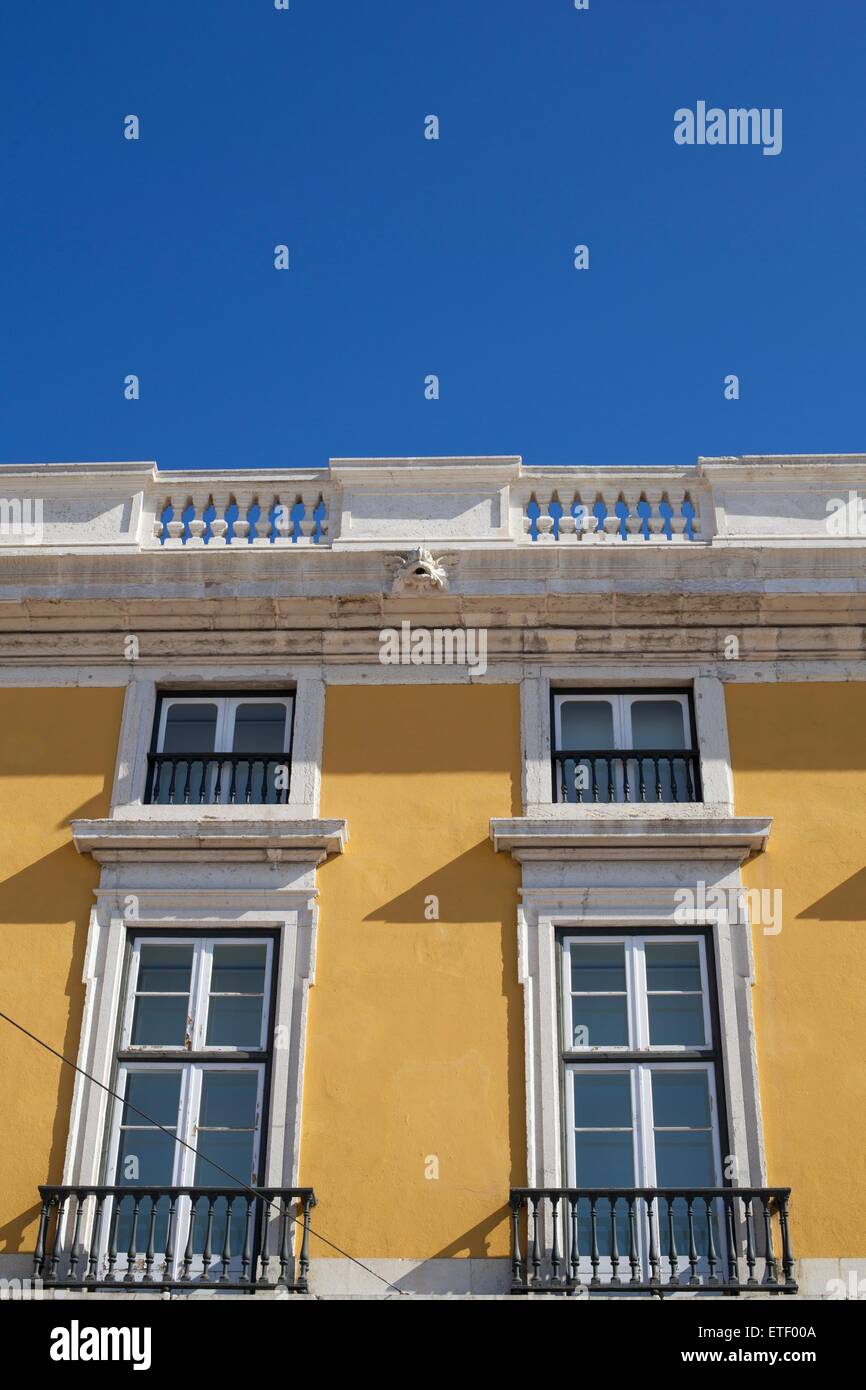Colourful buildings in Praca de Comercio of Lisbon against a bright blue sky in summer Stock Photo