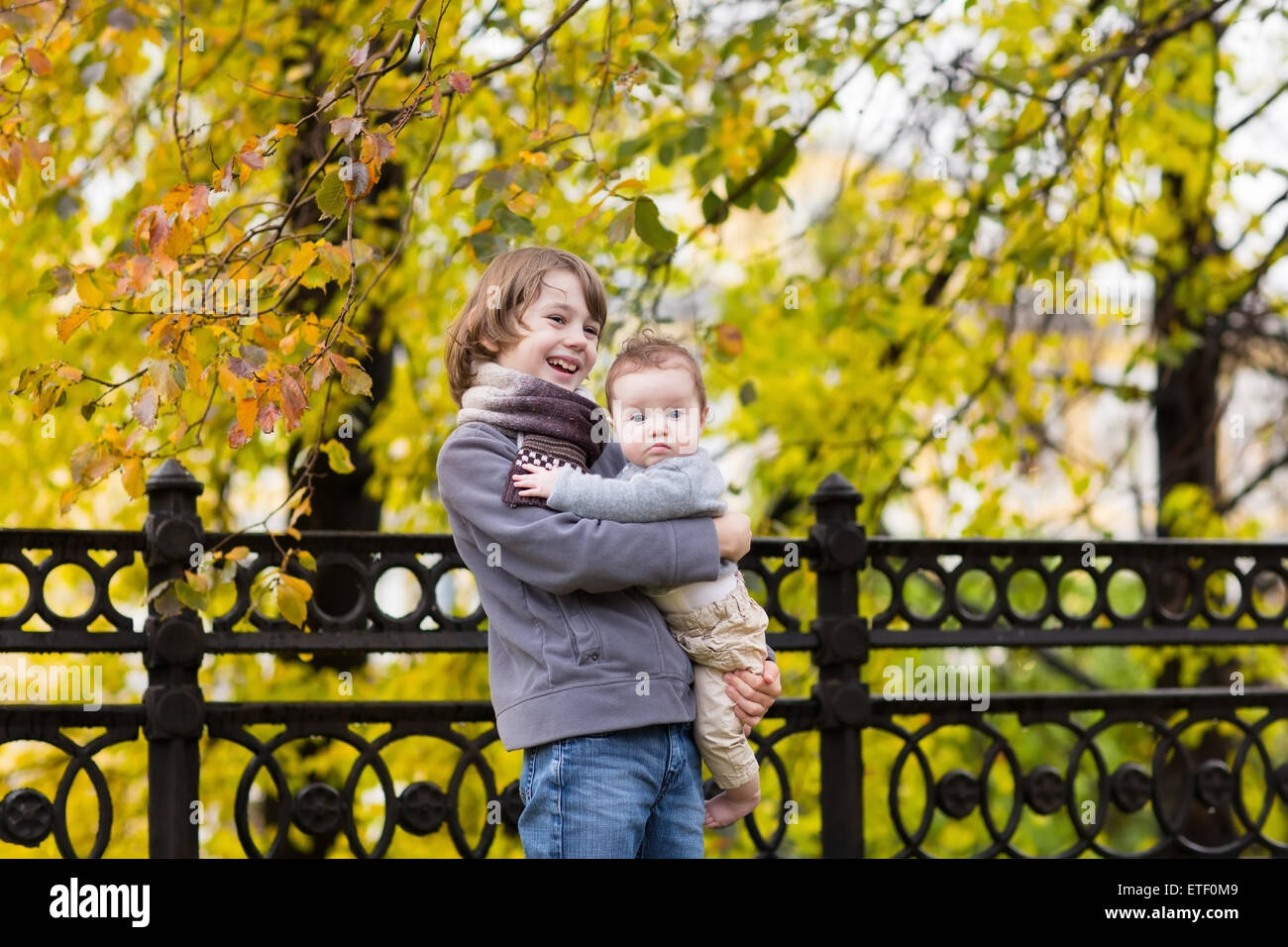 Brother and little sister in an autumn park Stock Photo - Alamy