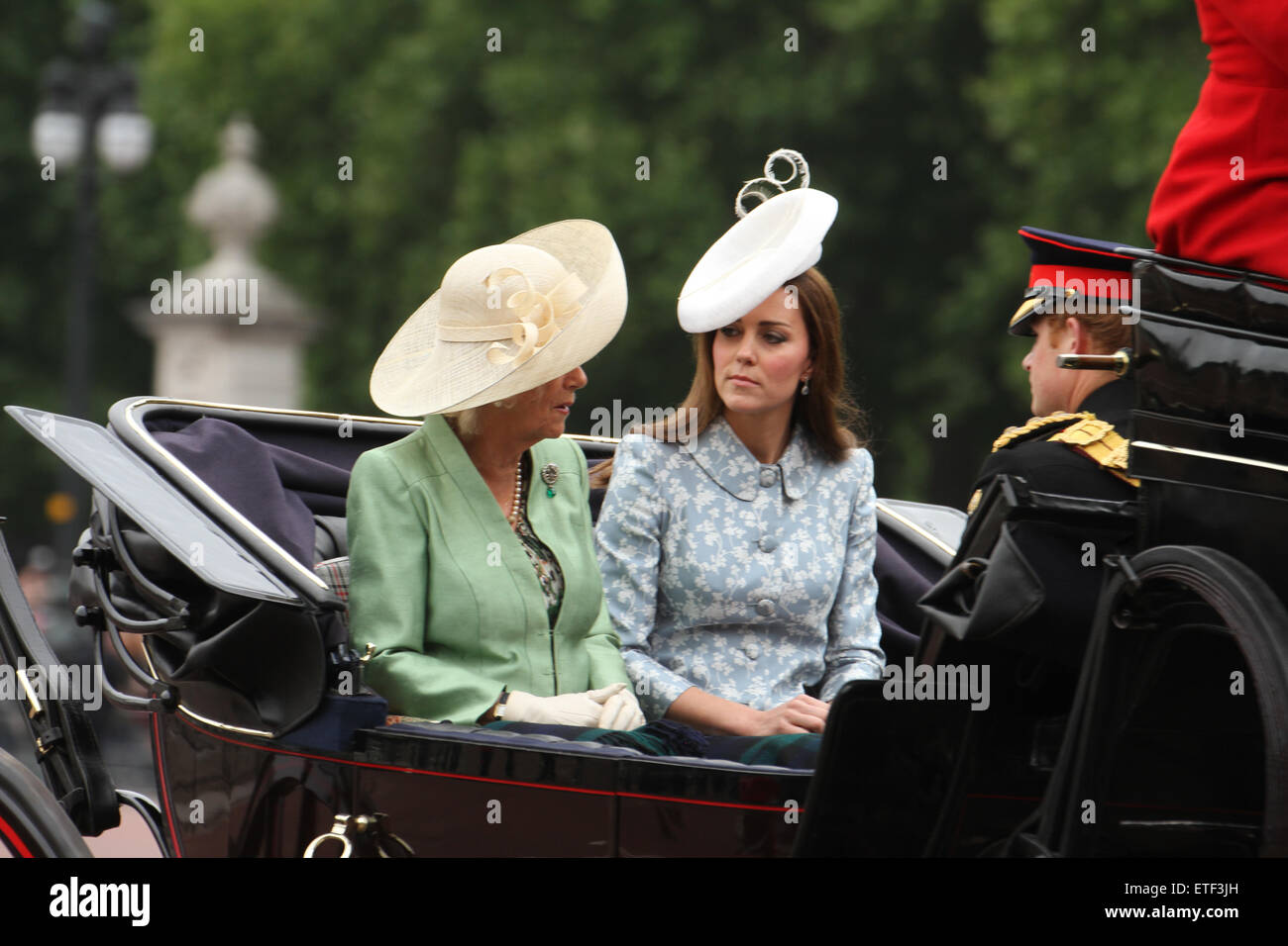 London, UK. 13th June, 2015. Camilla, Duchess of Cornwall with Catherine, Duchess of Cambridge and Prince Harry seen on a horse drawn carriage at the Mall.  .Since 1987, The Queen has attended in a carriage rather than riding, which she did before that on 36 occasions, riding side-saddle and wearing the uniform of the regiment whose Colour was being trooped. Credit:  david mbiyu/Alamy Live News Stock Photo