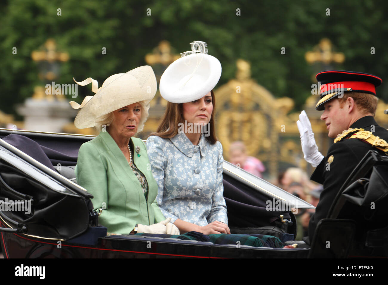 London, UK. 13th June, 2015. Camilla, Duchess of Cornwall with Catherine, Duchess of Cambridge and Prince Harry seen on a horse-drawn carriage at the Mall. .Since 1987, The Queen has attended in a carriage rather than riding, which she did before that on 36 occasions, riding side-saddle and wearing the uniform of the regiment whose Colour was being trooped. Credit:  david mbiyu/Alamy Live News Stock Photo
