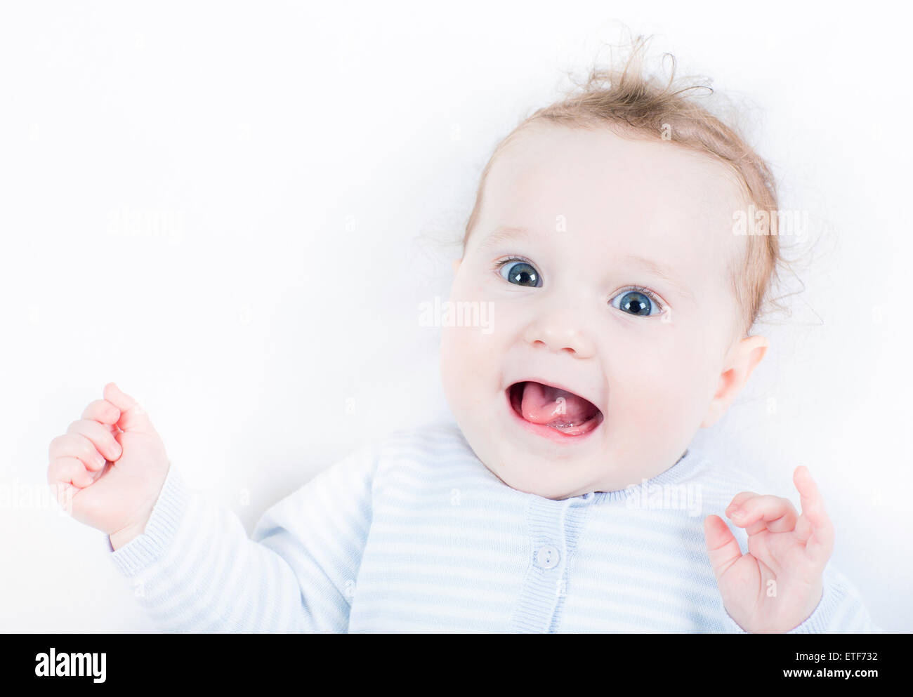Very funny baby girl showing her tongue Stock Photo - Alamy