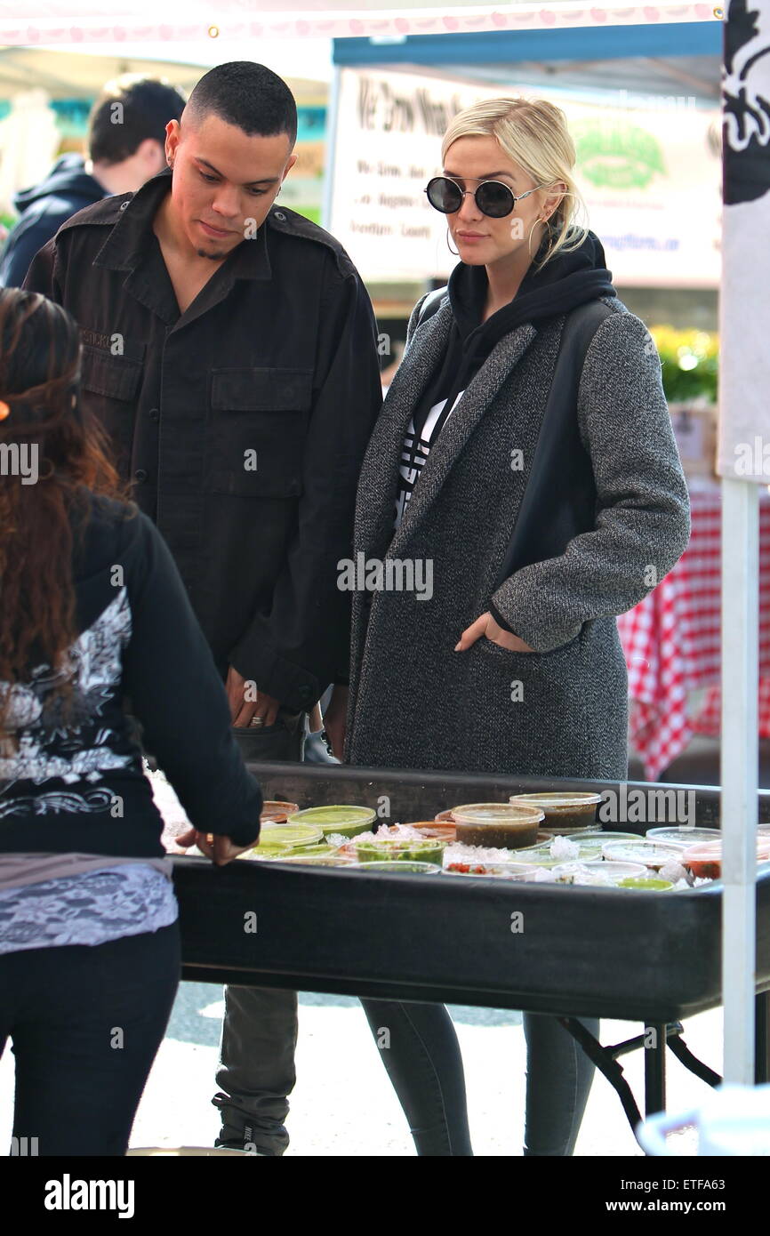 Ashlee Simpson and husband Evan Ross holding hands on a romantic outing