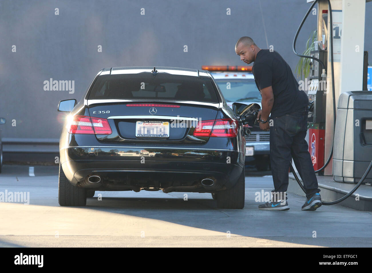 Scrubs actor Donald Faison pumping gas in his Mercedes in West