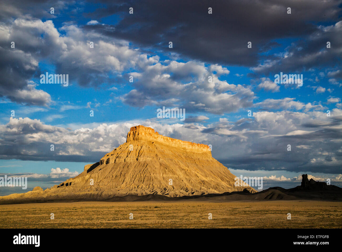 Located along the east end of the road to Capitol Reef National Park, the iconic shape of Factory Butte... Stock Photo