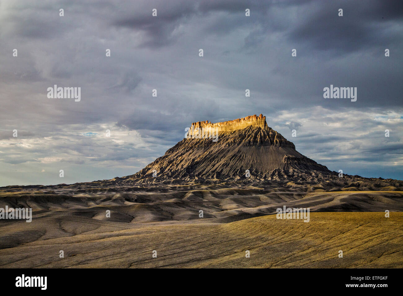 Located along the east end of the road to Capitol Reef National Park, the iconic shape of Factory Butte... Stock Photo