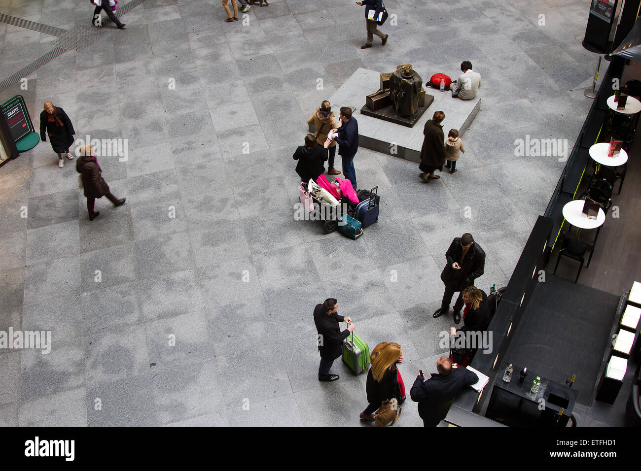 The Atocha Train Station. Busy commuters go about their business in the Atocha Railway Station in Madrid. Stock Photo