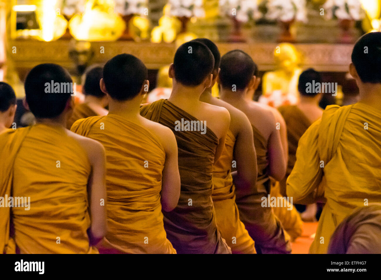 Asia. Thailand, Chiang Mai. Wat Phra Singh. Monks praying. Stock Photo