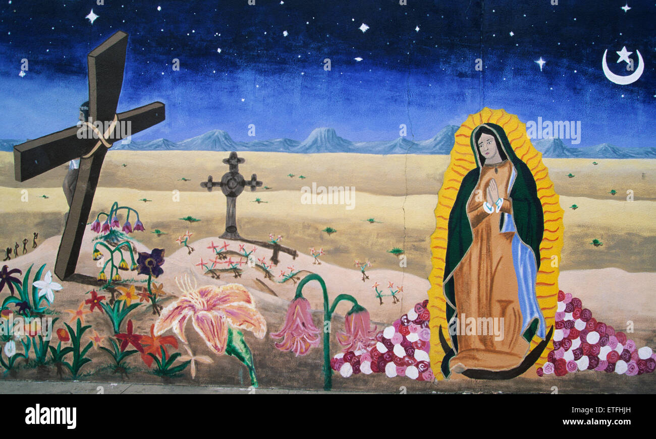 This exotic mural in the South Central district of Albuquerque, New Mexico, with its Salvador Dali like curving cross, wilting. Stock Photo