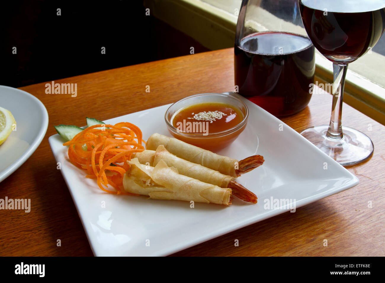 Fried prawns wrapped in pastry skin with plum sauce. Prawn presented