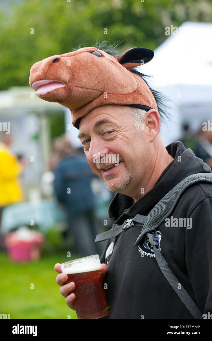 Llanwrtyd Wells, UK. 13th June 2015. Horse headgear is de rigeur! Runners & horses compete in the 37 km Man V Horse marathon over rugged Welsh terrain. Gordon Green conceived the event in 1980 upon overhearing a pub debate whether man was equal to horse running cross country over distance. Huw Lobb was the first man to beat a horse and won the £1,000 annually escalating prize total of £25,000 in 2004. 2014 saw the reintroduction of escalating prize money and introduction of electronic timing. Credit:  Graham M. Lawrence/Alamy Live News. Stock Photo