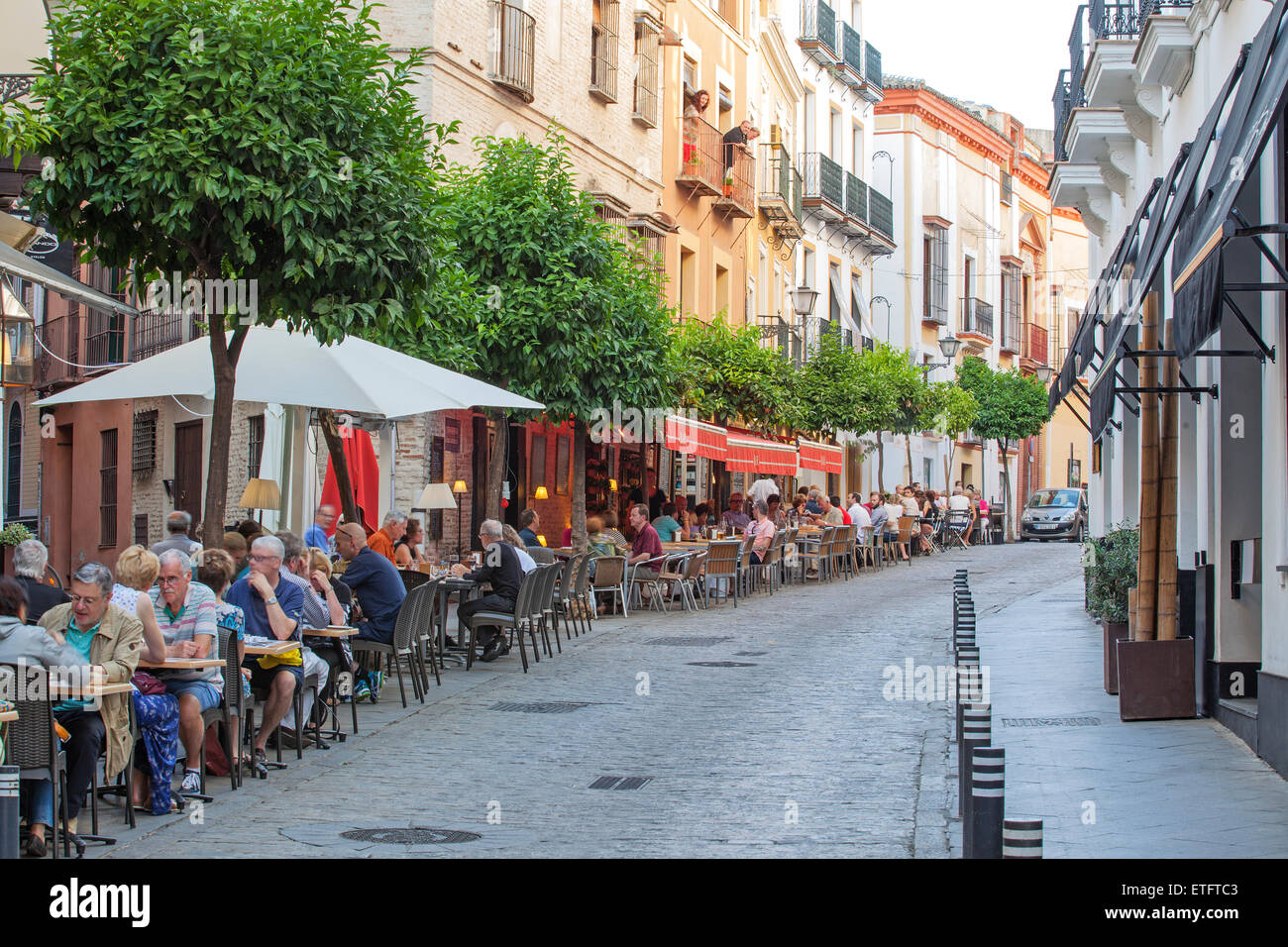 Seville - Calle Alvarez Quintero, street with people eating at outside cafes and resturants Stock Photo