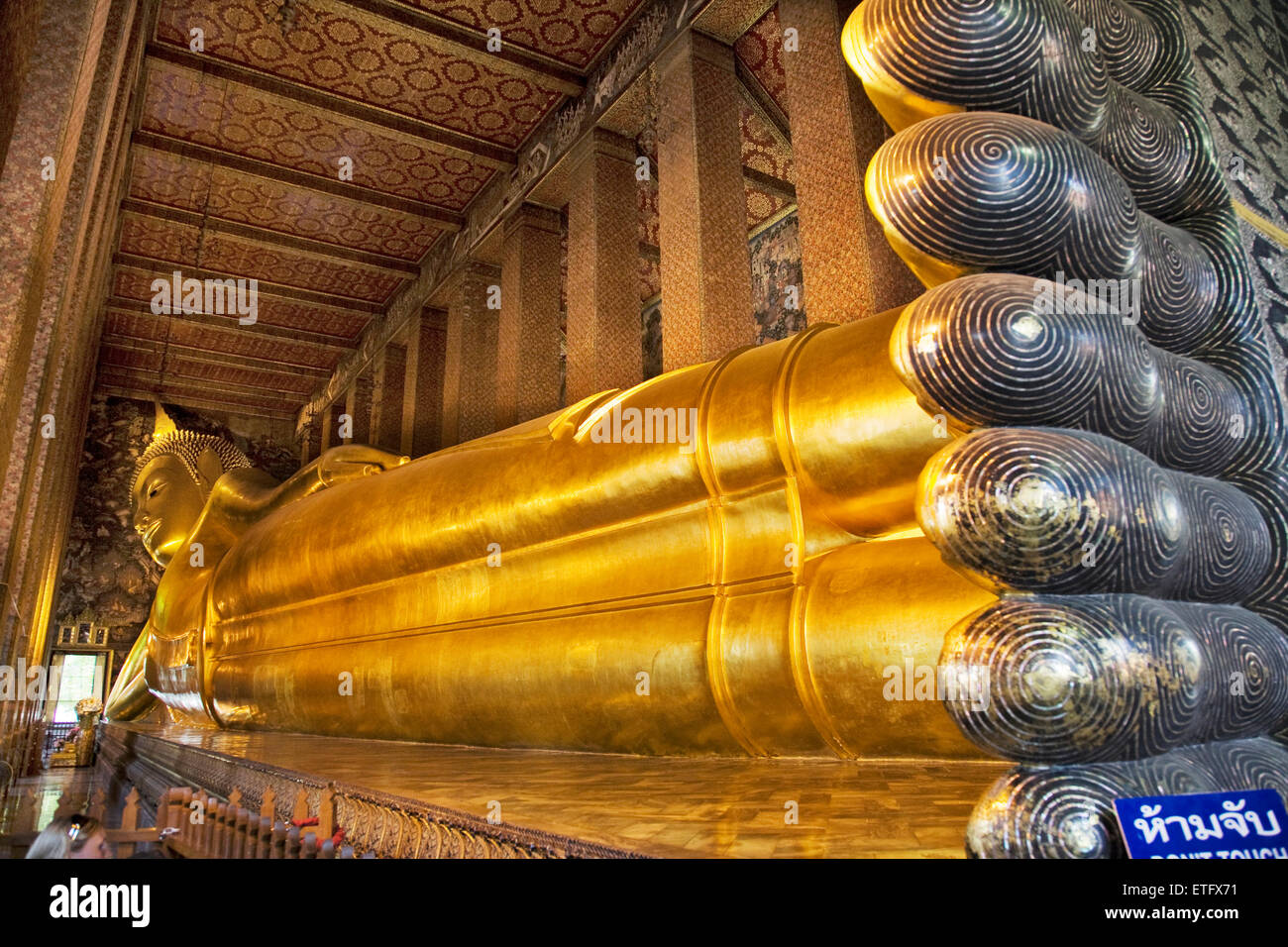 The reclining Buddha image at the temple of Wat Pho in Ko Rattanakosin in Bangkok is 45 metres long. Stock Photo