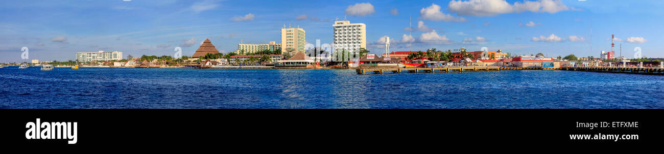 Panorama of Cozumel, Mexico with modern buildings, shoreline and dark blue water of the Caribbean Sea. Stock Photo