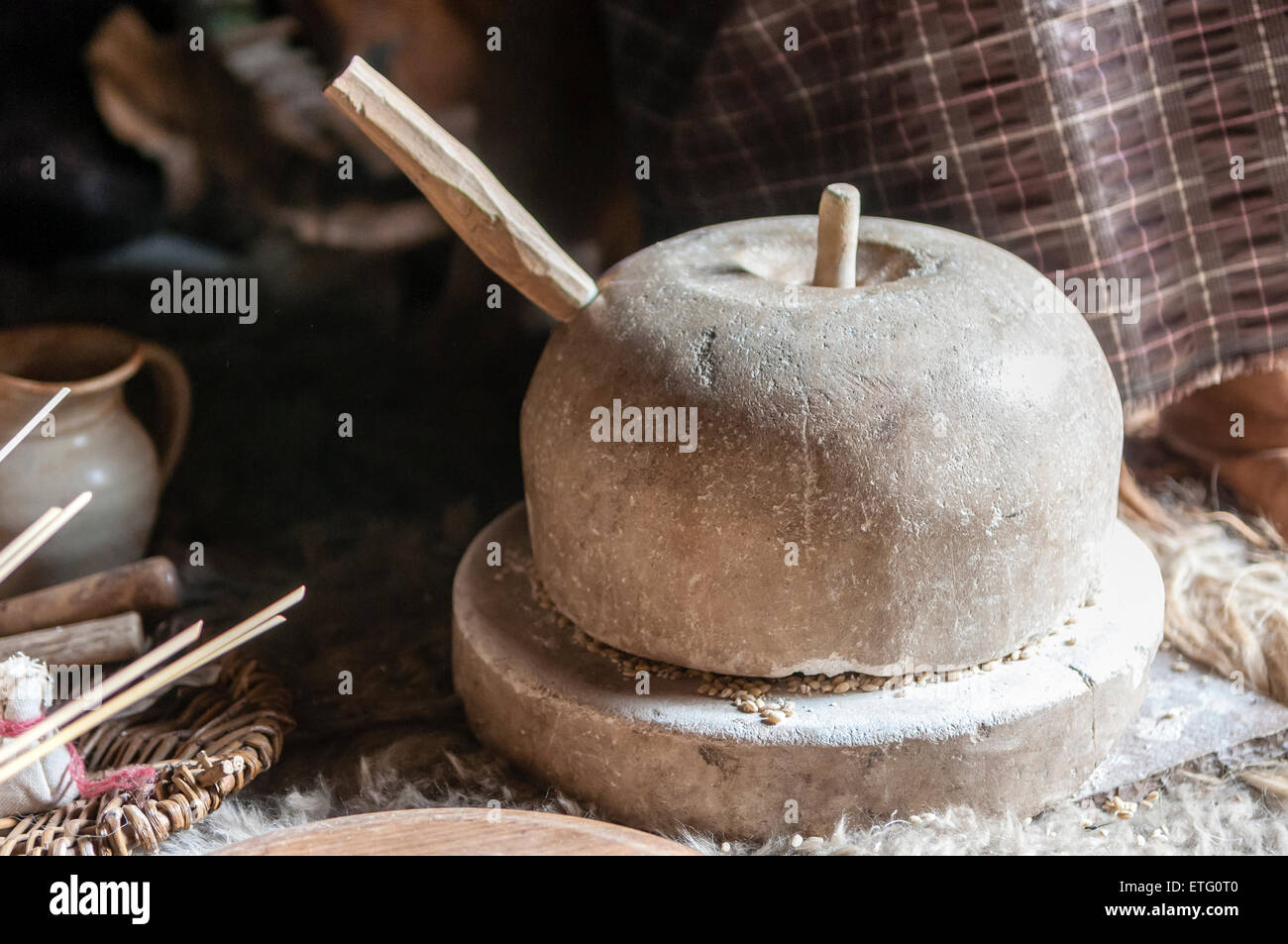 Heavy limestone grindstone as used by ironage people Stock Photo Alamy