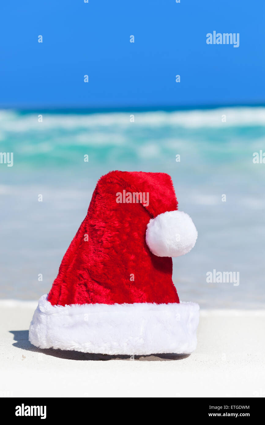 Santa Hat on white sandy beach on Caribbean sea background, New Year ...