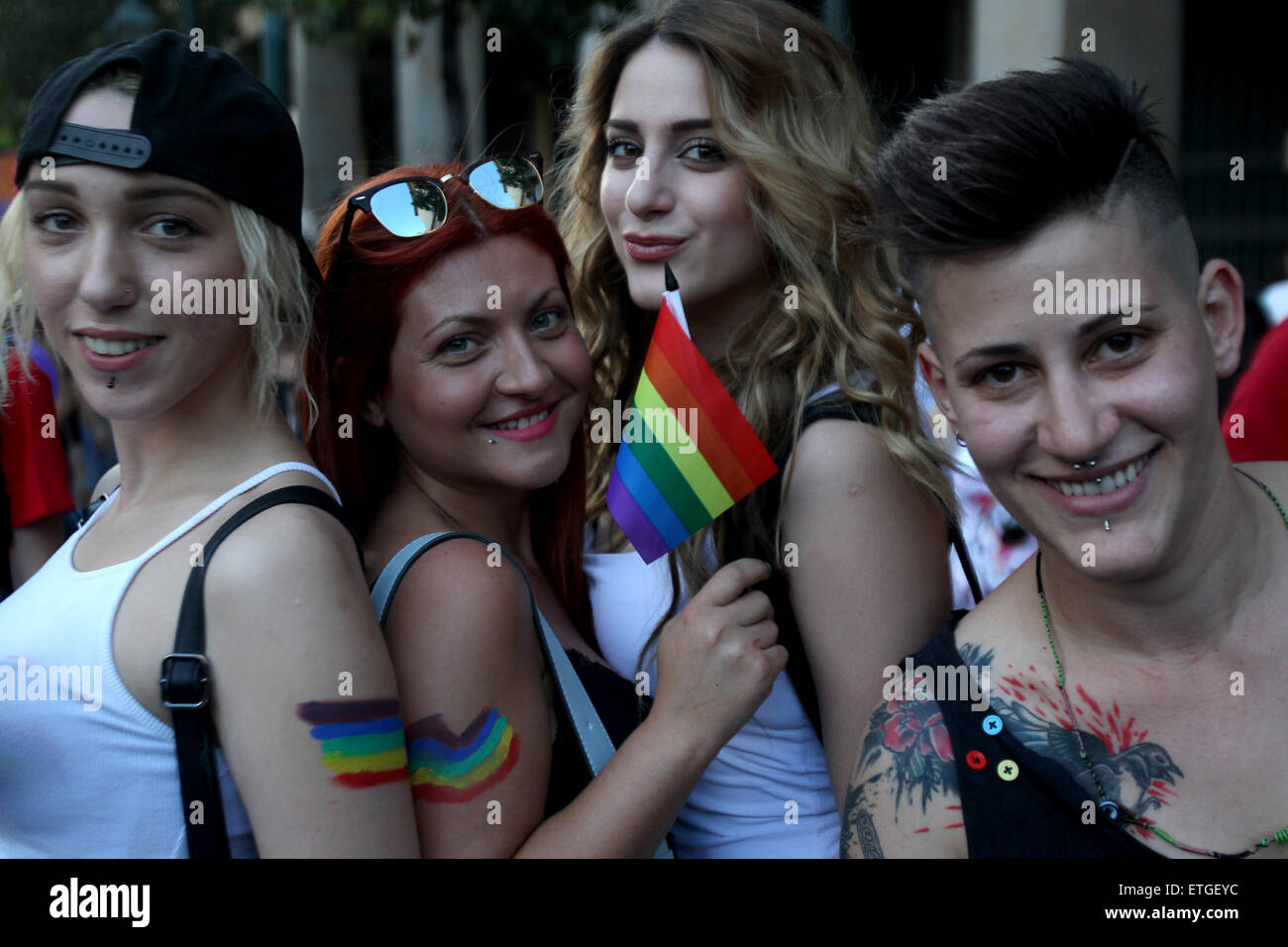 Athens, Greece. 13th June, 2015. Protesters pose with rainbow flags ...