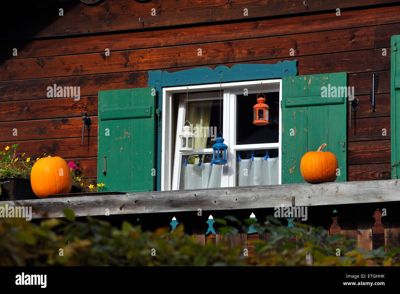 Autumn decoration with pumpkins on a balcony of a bavarian wooden house at Koenigssee Bavaria Germany Europe Stock Photo