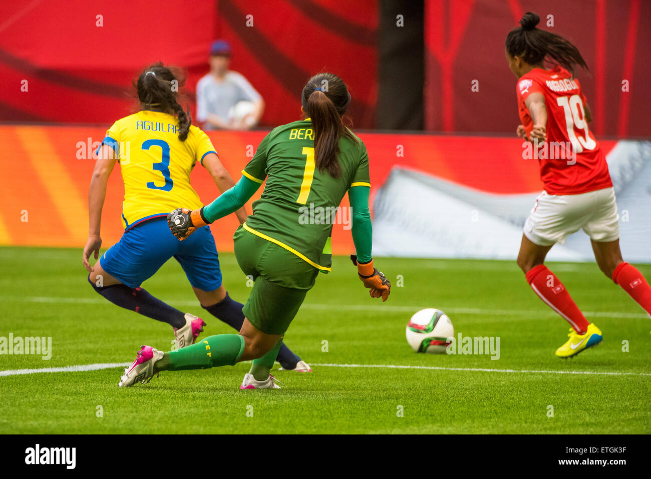 Vancouver, Canada - June 12, 2015: Ecuador goalkeeper Shirley BERRUZ (#1) moves to defend an attack from Switzerland forward Eseosa AIGBOGUN (#19) during the opening round match between Switzerland and Ecuador of the FIFA Women's World Cup Canada 2015 at BC Place Stadium. Switzerland won the match 10-1. Stock Photo