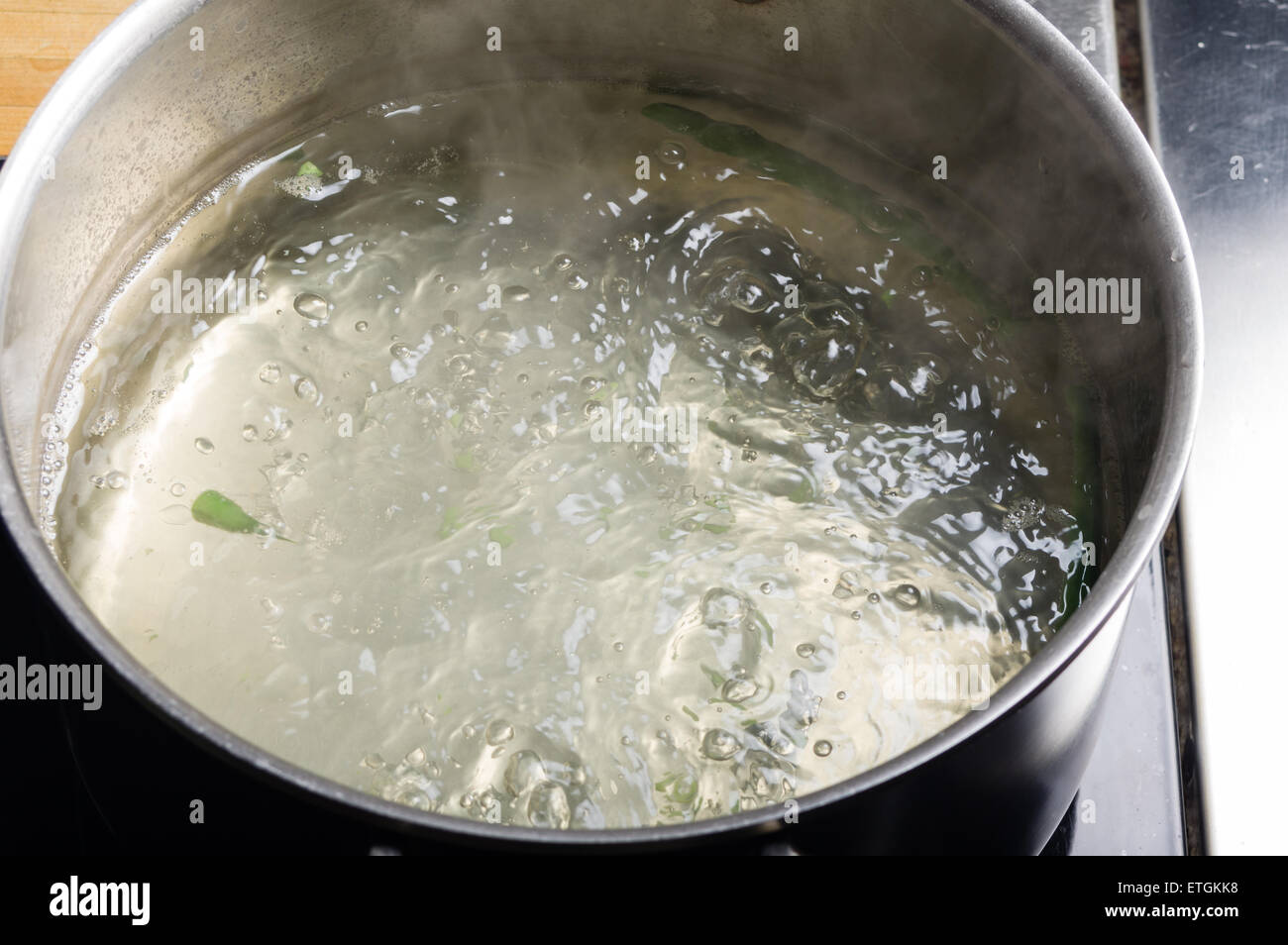 Hot boiling water in cook pot on stove Stock Photo