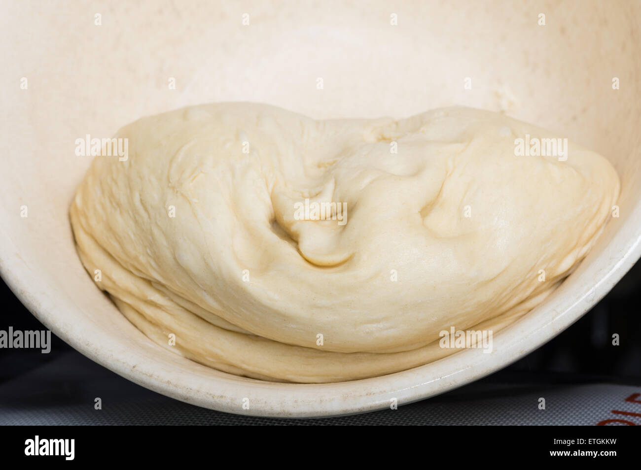 Bread dough rising in a bowl waiting to knead Stock Photo