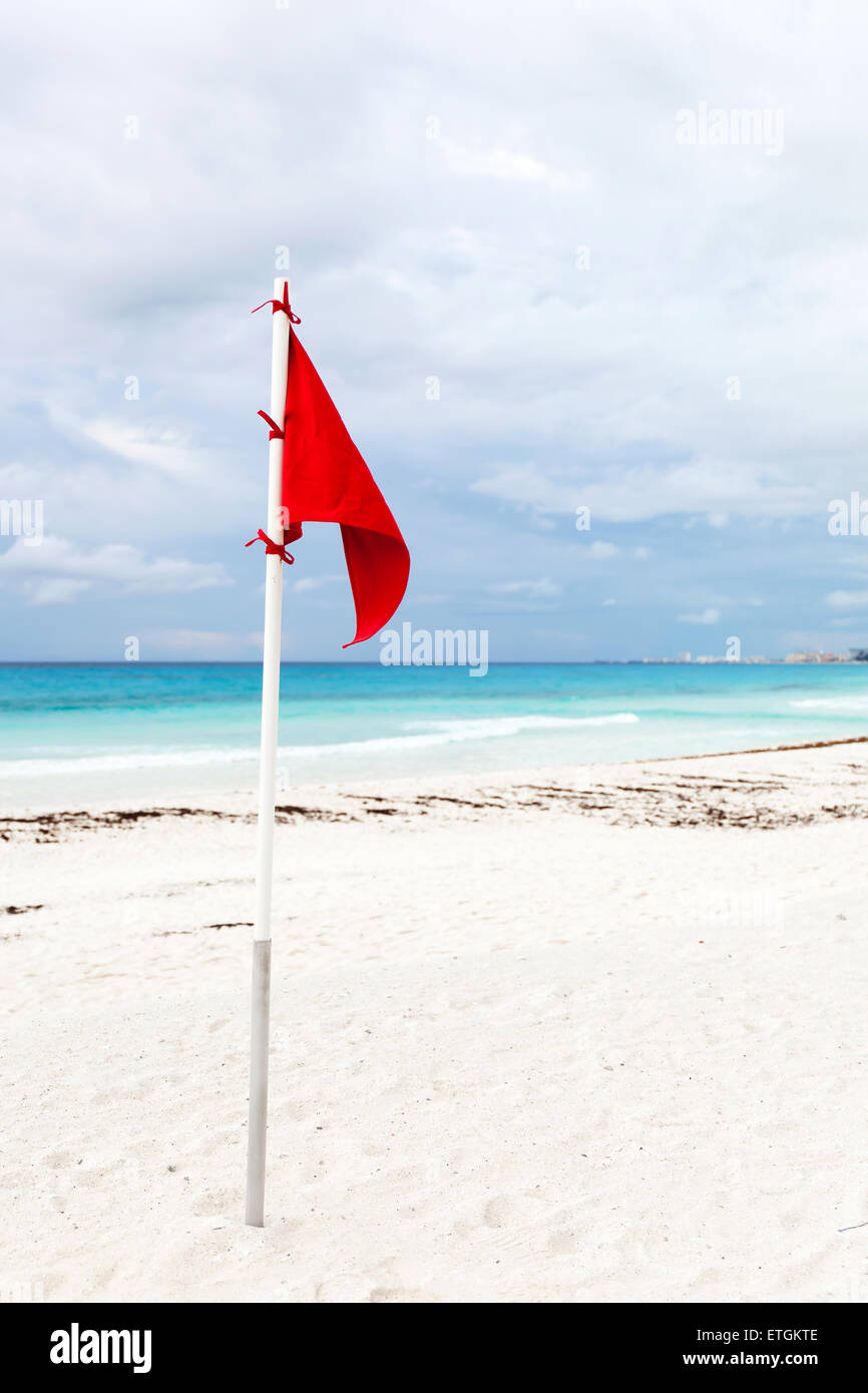Lifeguard red flag at caribbean beach in bad weather Stock Photo