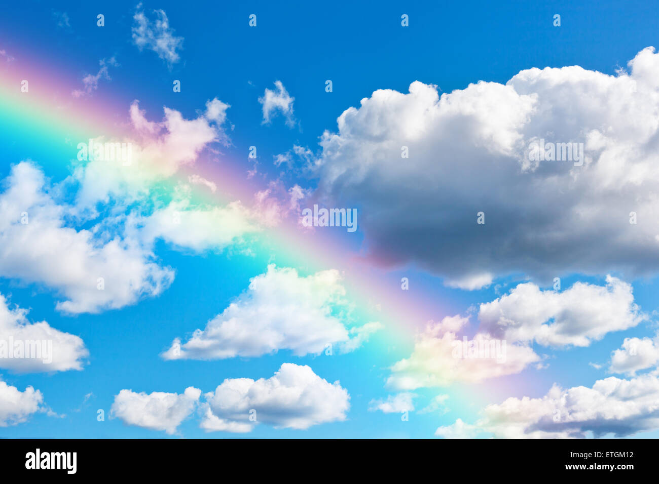 Blue cloudly sky background with colorful rainbow Stock Photo - Alamy