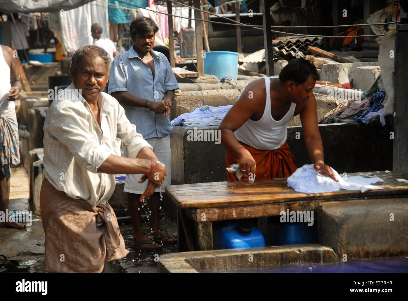 Men washing clothes at Mahalaxmi Dhobi Ghat open air laundromat, Mumbai
