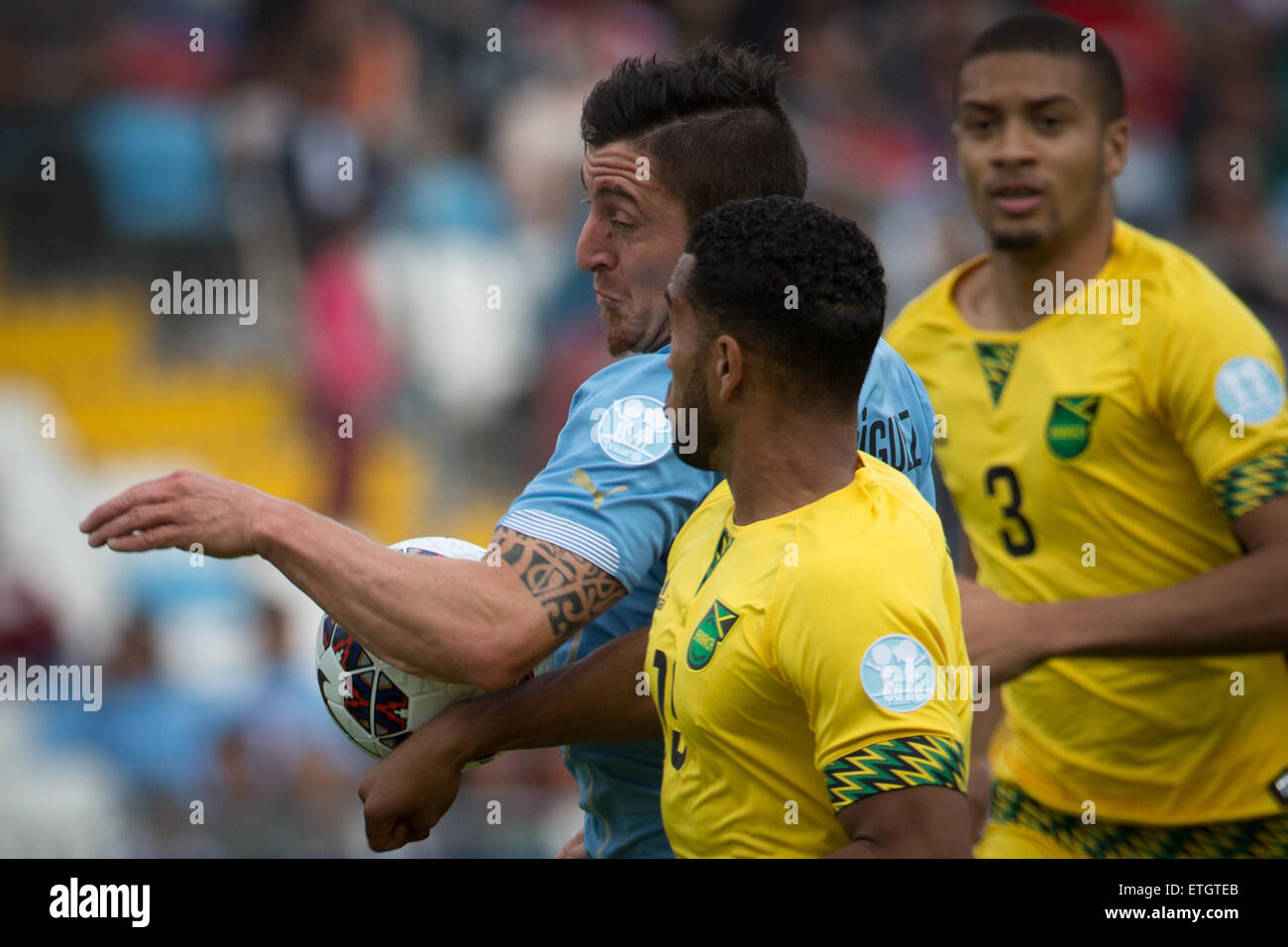 Antofagasta, Chile. 13th June, 2015. Cristian Rodriguez (L) of Uruguay vies with Cristian Rodriguez of Jamaica during a Group B match at Copa America 2015, in Antofagasta, Chile, on June 13, 2015. Uruguay won 1-0. © Pedro Mera/Xinhua/Alamy Live News Stock Photo