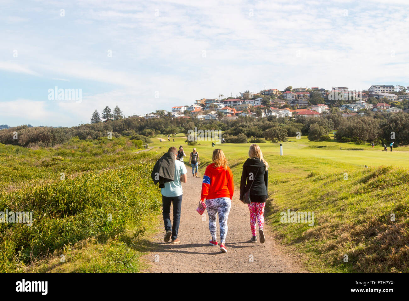 young people enjoying a walk on Sydney northern beaches beside long