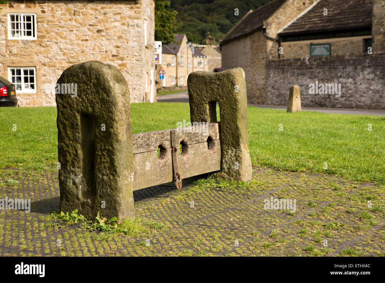 UK, England, Derbyshire, Eyam, Market Square, early C19th stone an wooden punishment stocks Stock Photo
