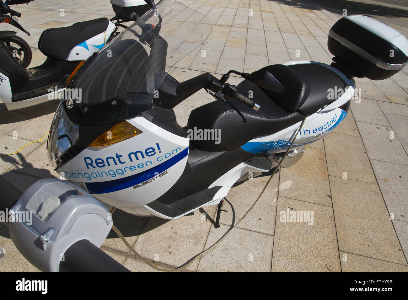Recharging electric motorcycle. Electric motorcycle rental Stock Photo