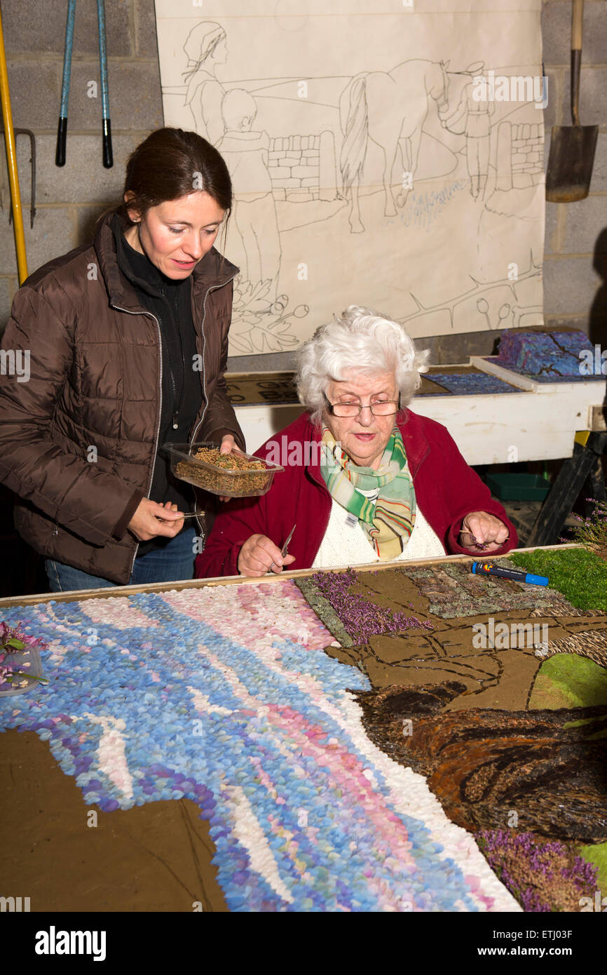 UK, England, Derbyshire, Eyam, volunteers constructing the Requisitioning of Horses 2014 well dressing Stock Photo