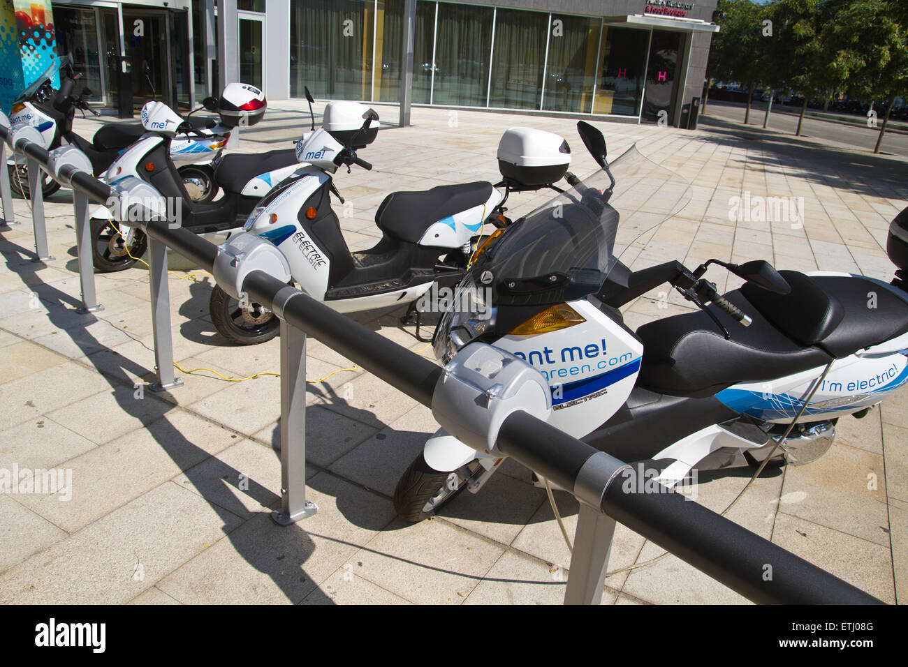 Recharging electric motorcycle. Electric motorcycle rental Stock Photo