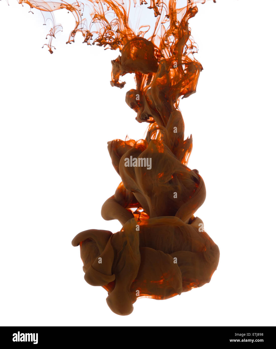 Studio shot of brown ink in water, isolated on white background Stock Photo