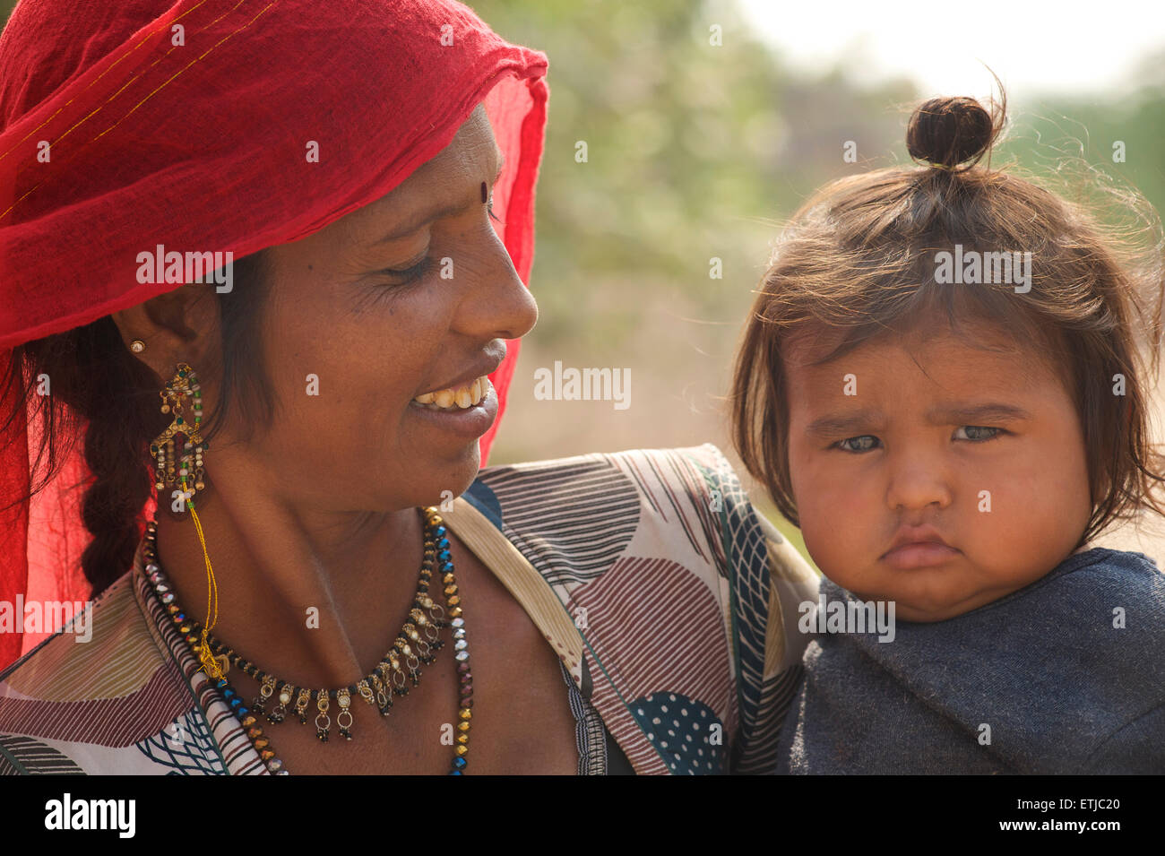 Indian woman in sari with her child in arms. Jodhpur, Rajasthan, India ...