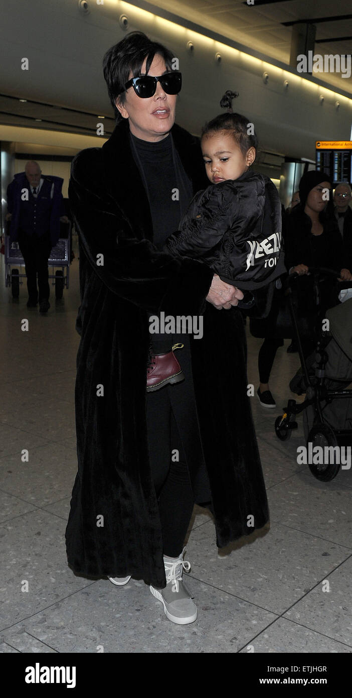 Kris Jenner, wearing a pair of Kanye West x Adidas Originals Yeezy 750  Boost, arrives at Heathrow Airport carrying baby North West, who was  wearing a 'Yeezus Tour" bomber jacket in support