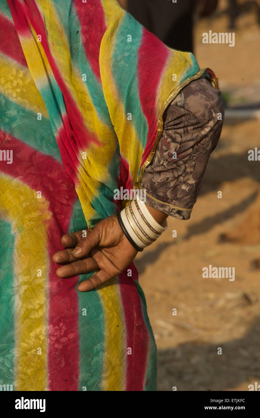 Detail of Rajasthani woman's colourful sari and bracelets. Pushkar, Rajasthan, India Stock Photo