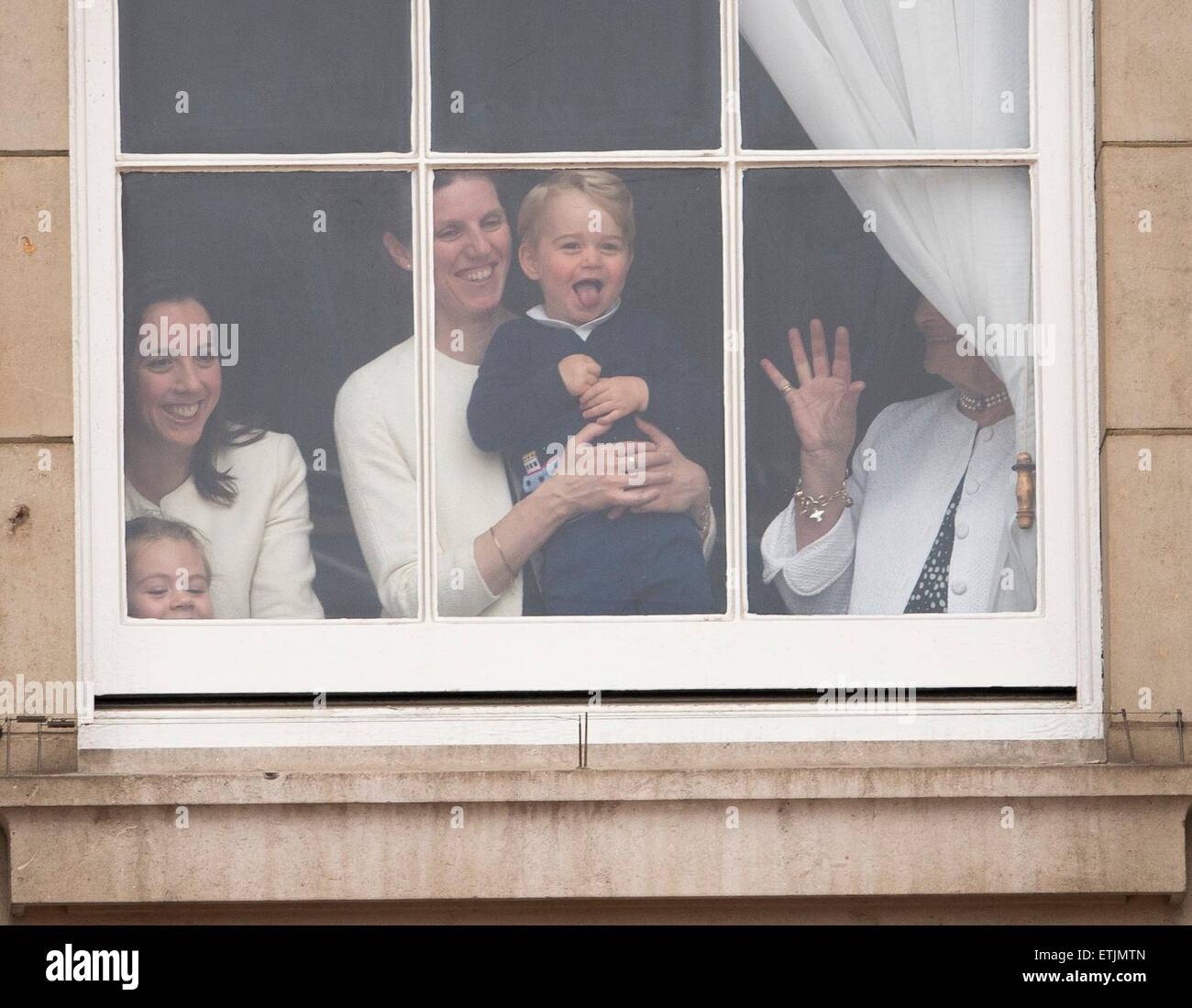 Britian's Prince George is held by a nanny as he waves through a window of Buckingham Palace 13 June 2015 while the Royal Family head for Horse Guards Parade nearby for the annual Trooping the Colour ceremony to mark the monarch's official birthday. Photo: Patrick van Katwijk/ POINT DE VUE OUT - NO WIRE SERVICE - Stock Photo