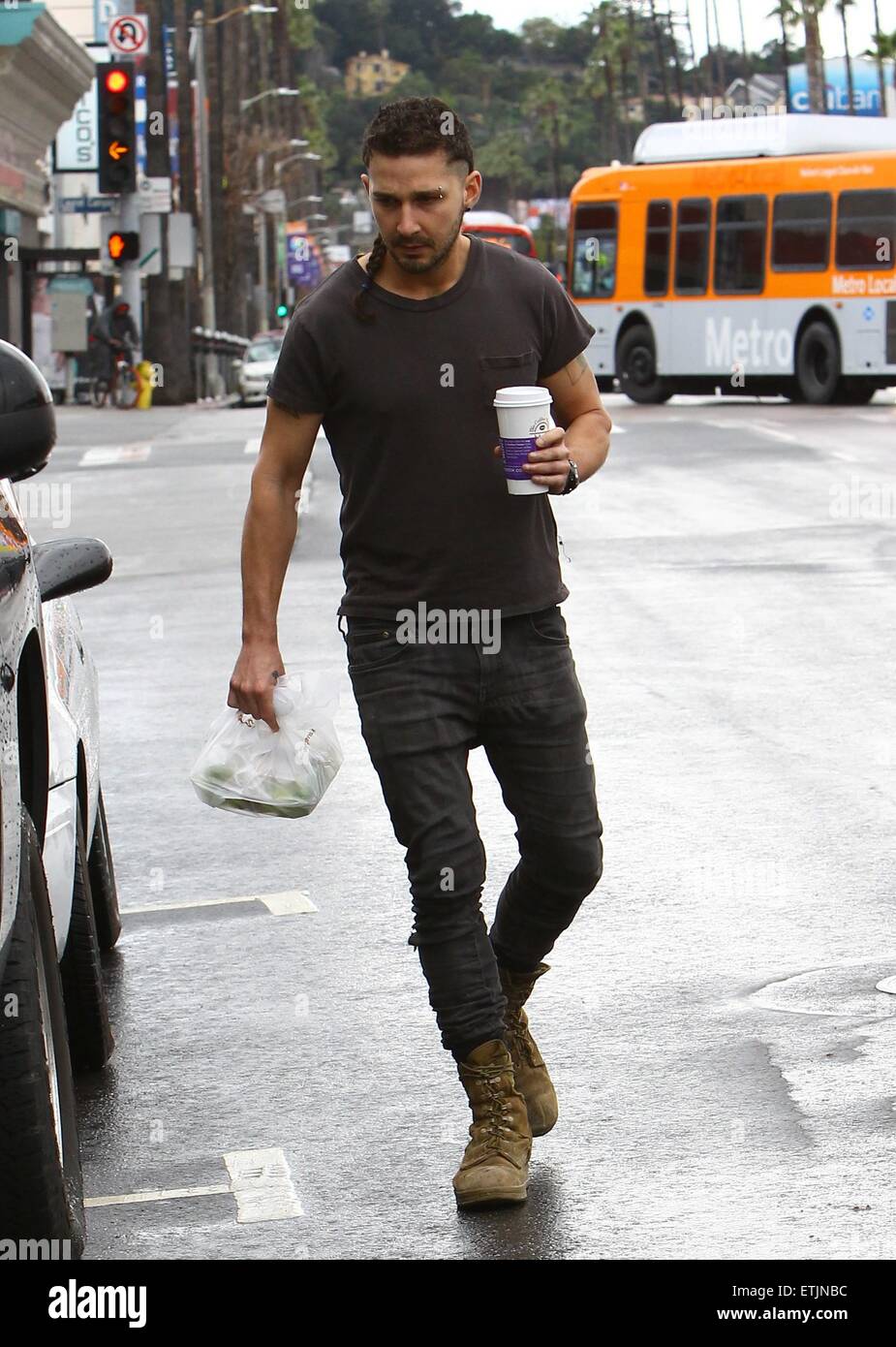 Shia LaBeouf, sporting a new rattail style haircut, grabs himself