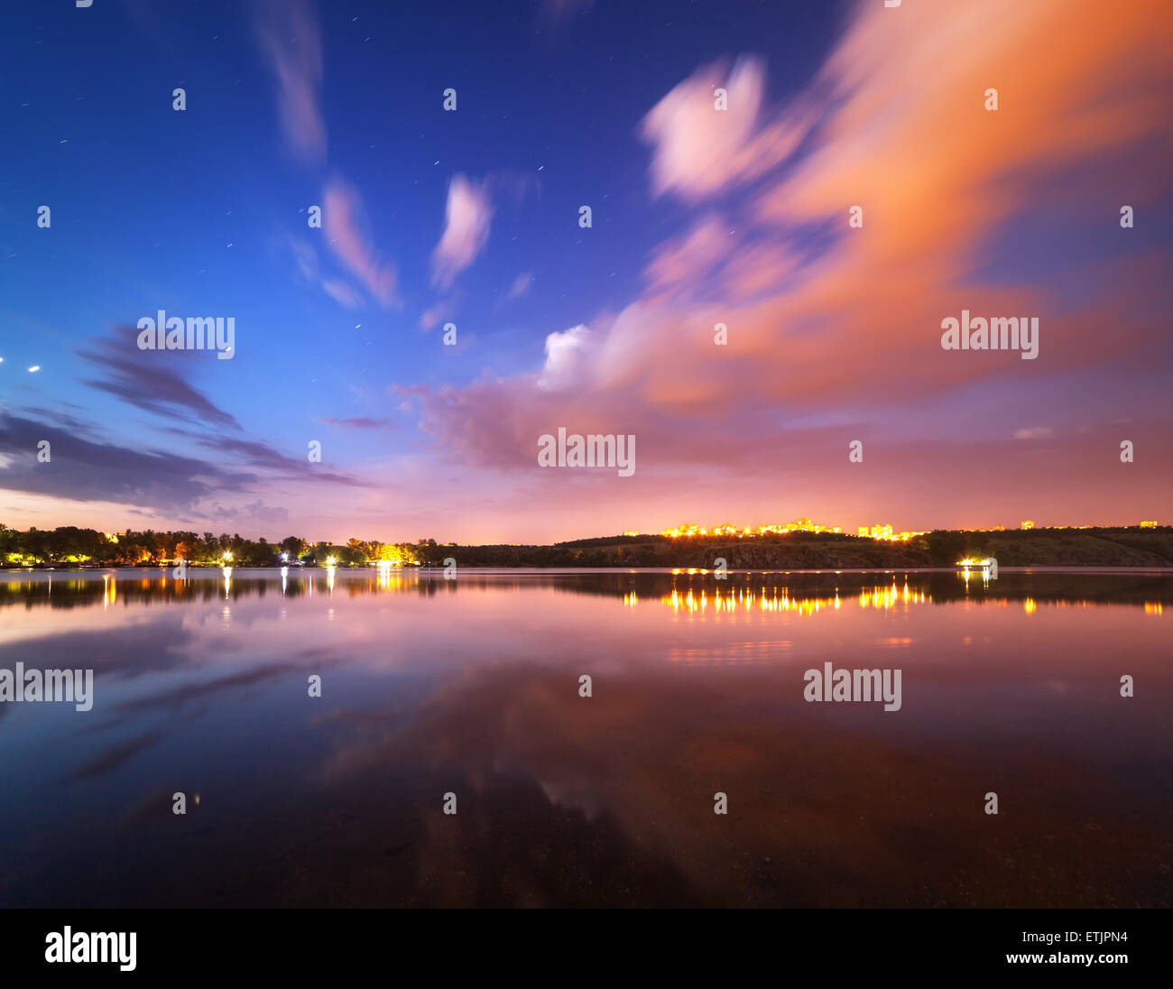 Beautiful night sky at the river with stars, clouds and reflections in the water. Summer in Ukraine Stock Photo