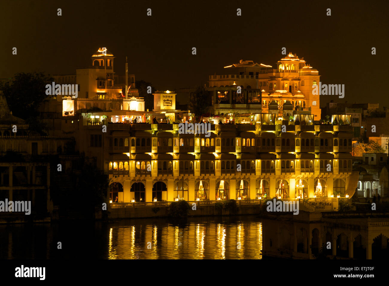 Night view across part of Lake Pichola to the City Palace, Udaipur, Rajasthan, India Stock Photo