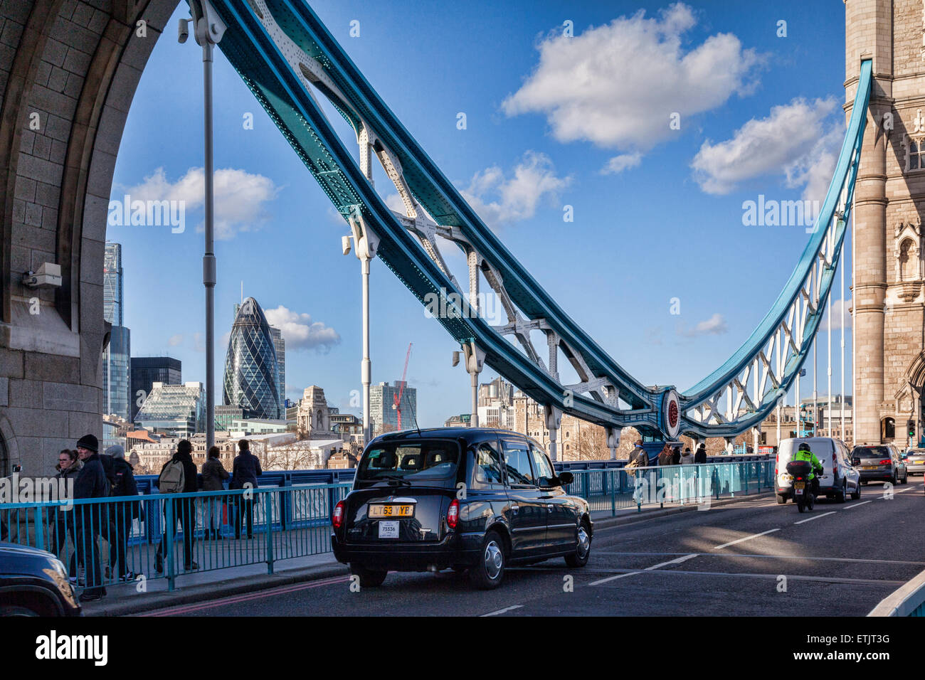Black taxi cab on Tower Bridge on a bright sunny winter day, London, England, UK. Stock Photo